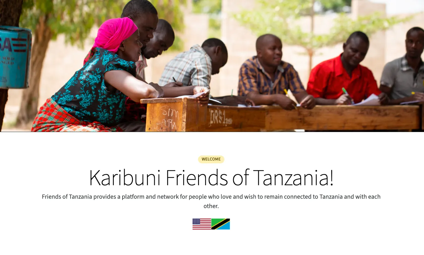Image of the new homepage featuring a large hero image of a Tanzanian woman attending a meeting